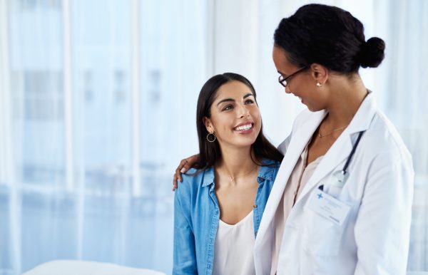 Young woman has conversation with doctor